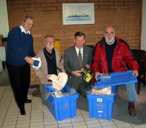 Several members filling an Aqua box before sending off to store for despatch to a disaster area.
